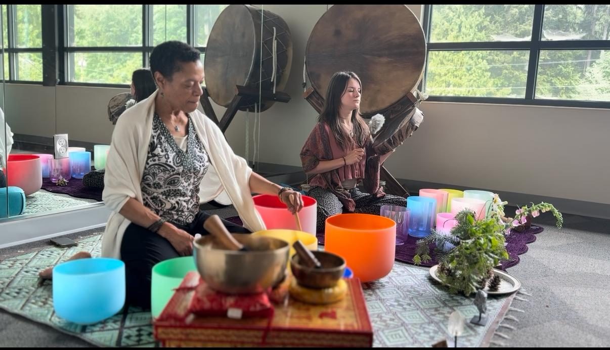 Two practitioners with crystal bowls
